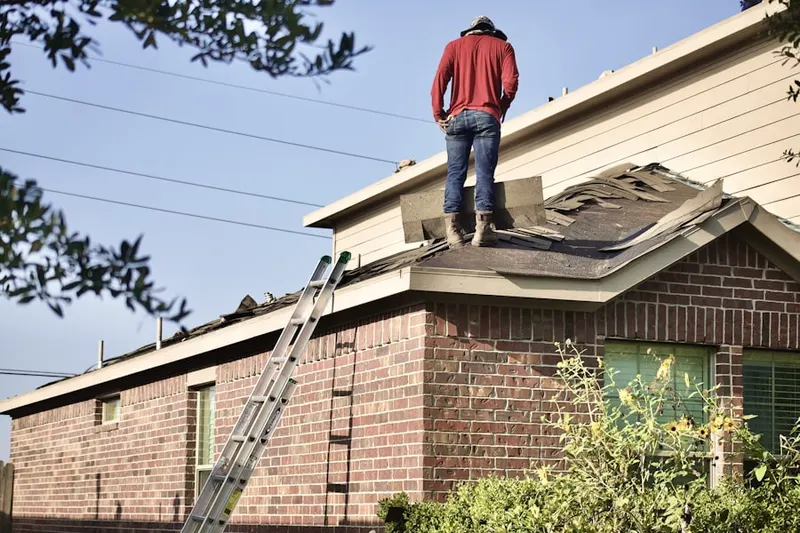 Professional roofer working on a residential roof in Thorofare